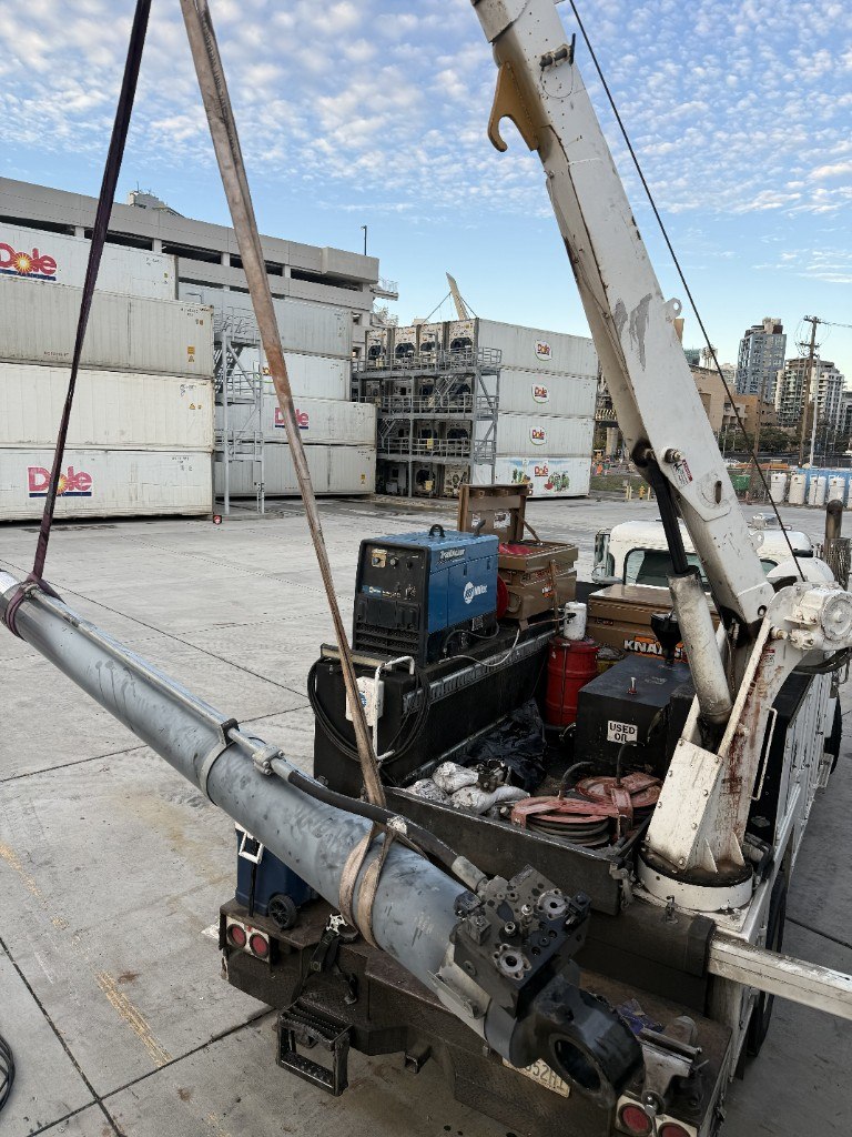 Mobile service truck lifting a hydraulic cylinder on site